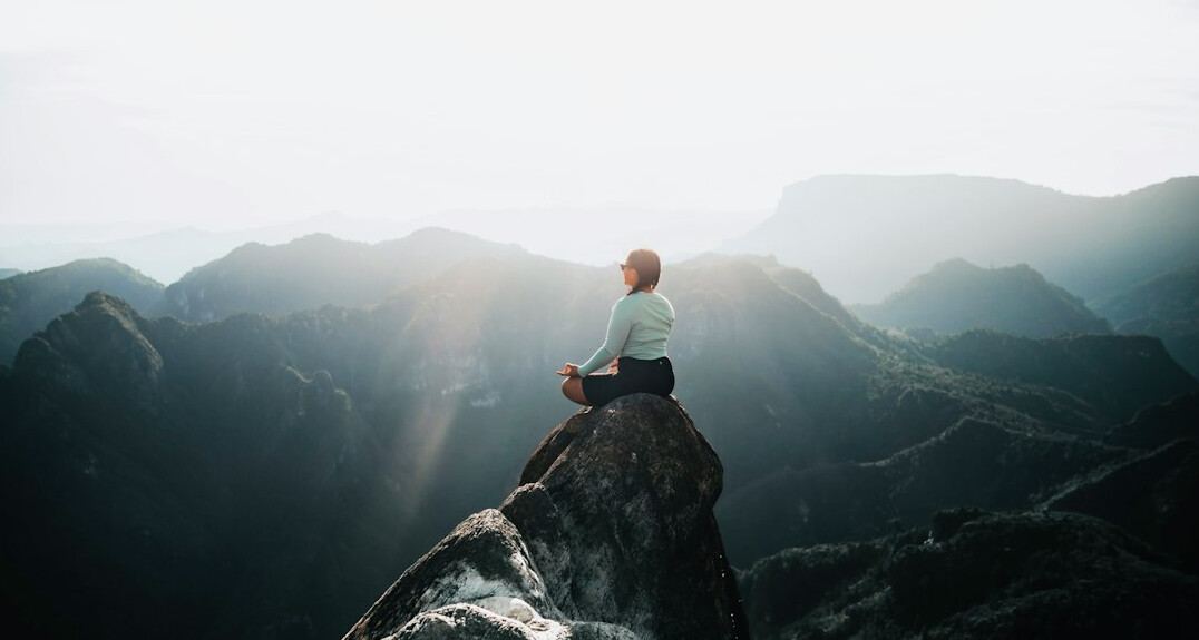 person meditating alone
